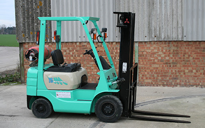 A parked teal Forklift on the forklift training page